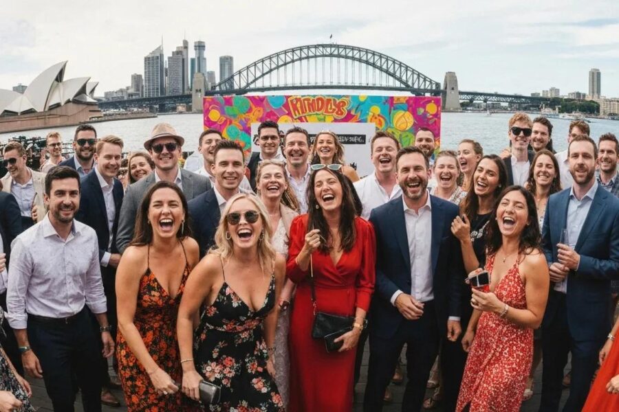 Guests laughing and posing at a vibrant Sydney event with a photobooth