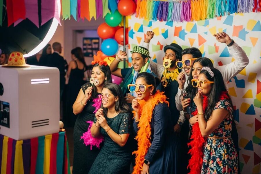 Colorful photo booth setup with guests enjoying the experience at an event