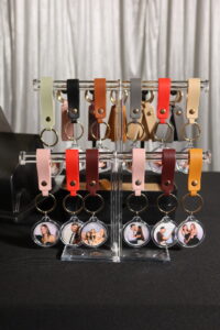 Photo Booth Keychain Station set up at a Sydney wedding with personalised keychains and coloured leather tassels.