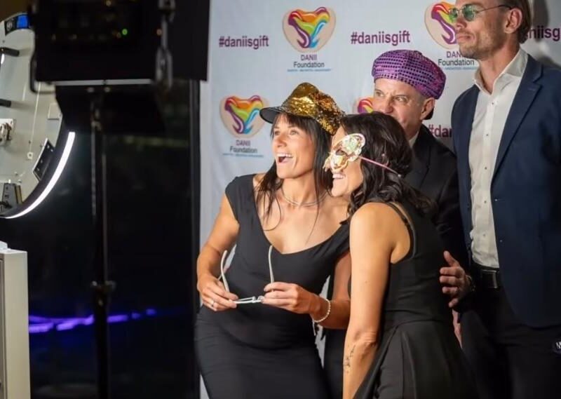 Open photo booth with branded backdrop at a corporate event, enhancing brand visibility