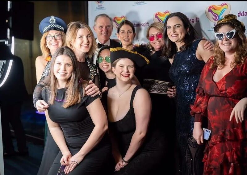 Colorful photo booth at a lively event in Sydney with guests enjoying taking photos