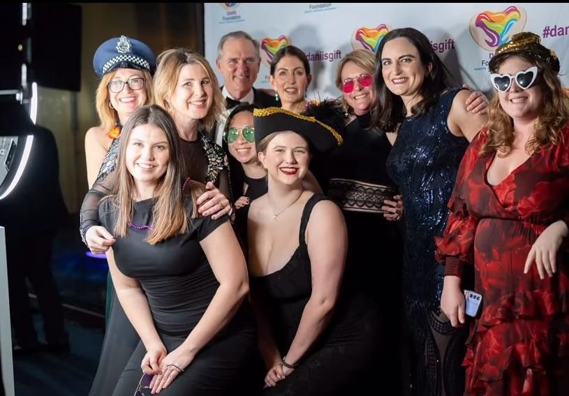 Guests enjoying a photo booth experience with various booth types and props