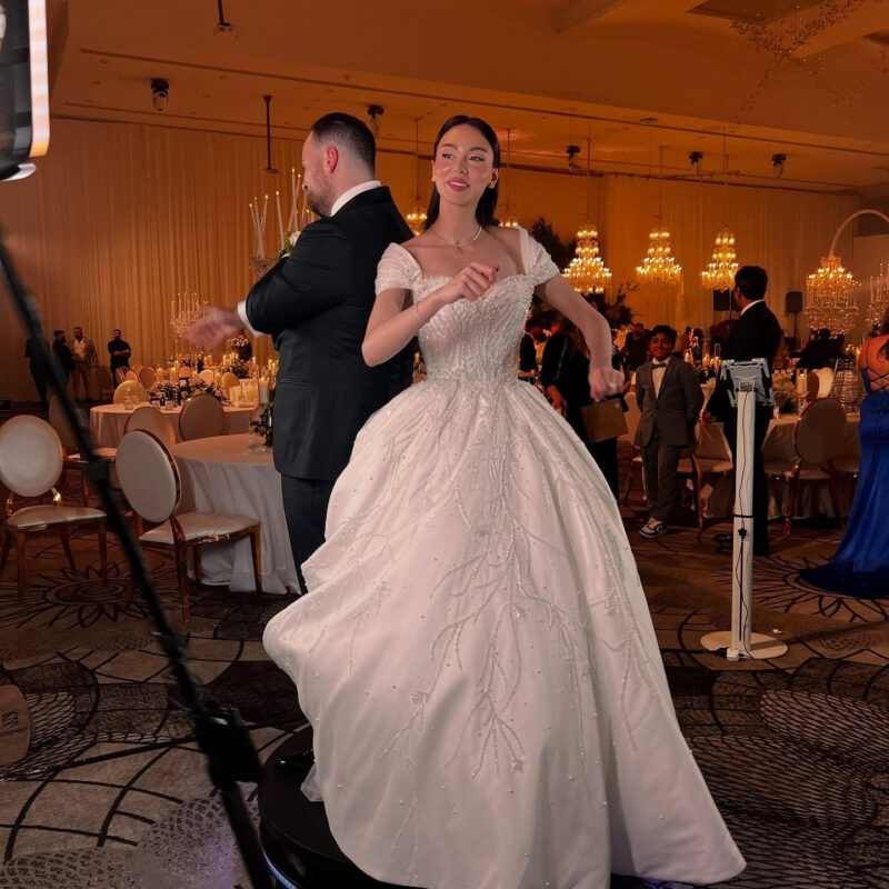 Person comparing photo booth vendor quotes on a laptop with notes and a calculator