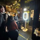 Guests holding their personalised Halo360 polaroid passport prints